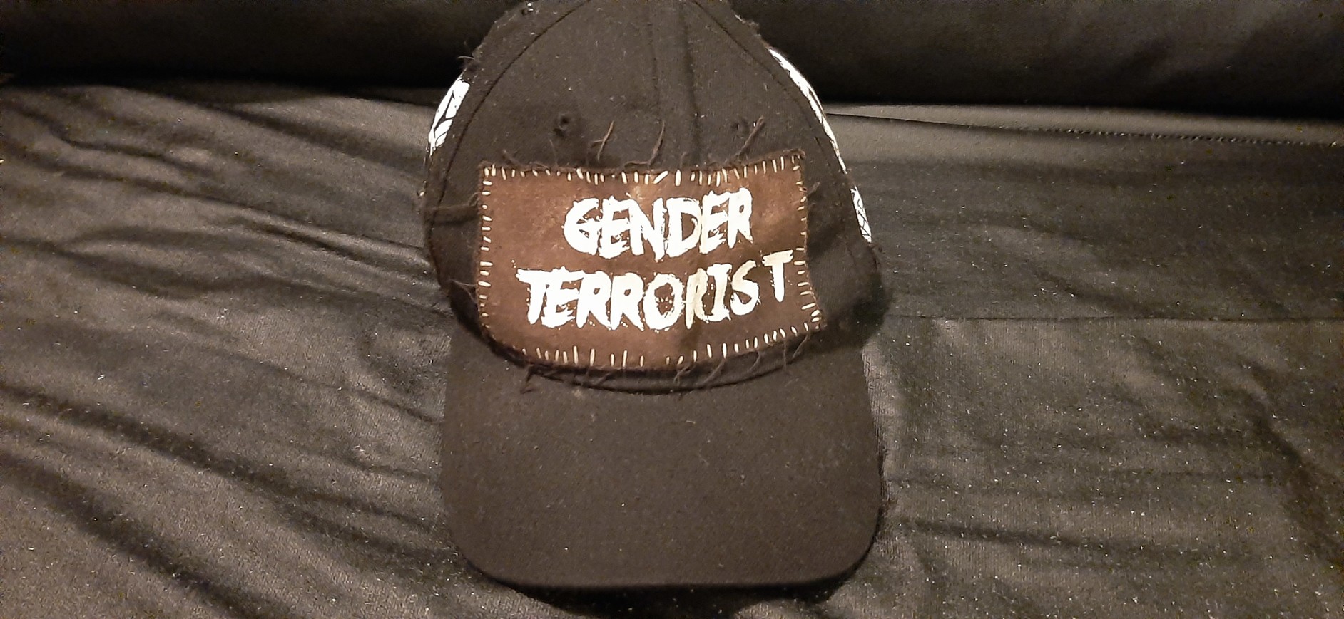 front of my DIY'd black gender terrorist hat, which is the gender terrorist patch'